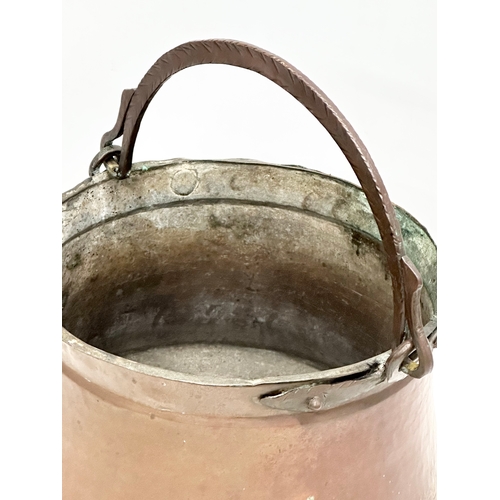 358A - A Late 19th Century copper pot with iron handle. 37x24cm