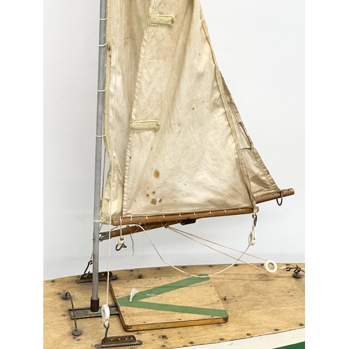 410A - A large Early/Mid 20th Century wooden pond yacht. 66x113cm