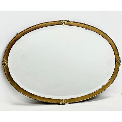 360A - A Late 19th/Early 20th Century brass framed bevelled mirror. Circa 1900. 82x57cm