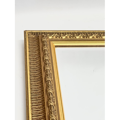 360B - A large Victorian style gilt framed bevelled mirror. 87x67cm