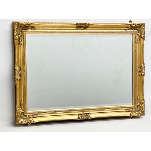 360C - A large Victorian style gilt framed bevelled mirror. 108x79cm