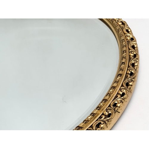 360F - A gilt framed bevelled mirror. 52x68cm