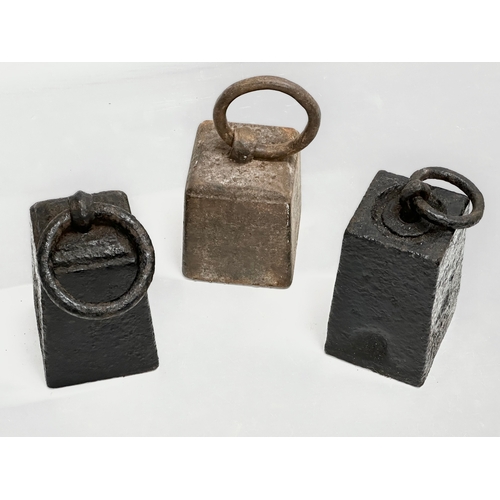 648 - 3 Late 19th Century iron weights. 15cm