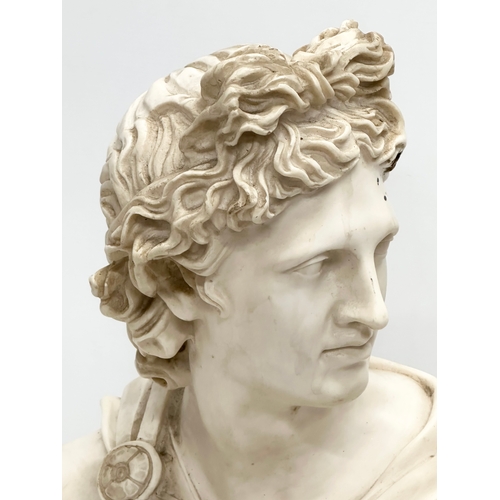 650 - A large heavy resin bust of Apollo on stand. 36x55cm