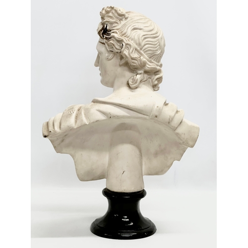 650 - A large heavy resin bust of Apollo on stand. 36x55cm