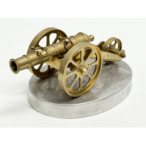 674 - 2 brass canons on stands. Wooden stand measures 31x16x16cm