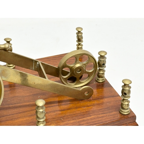 674 - 2 brass canons on stands. Wooden stand measures 31x16x16cm