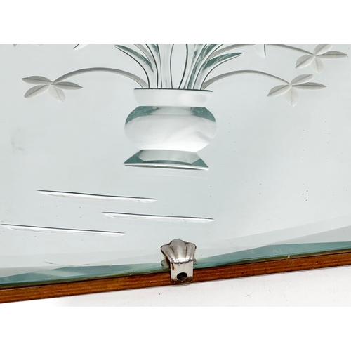 675 - An Art Deco bevelled mirror. 69x40cm