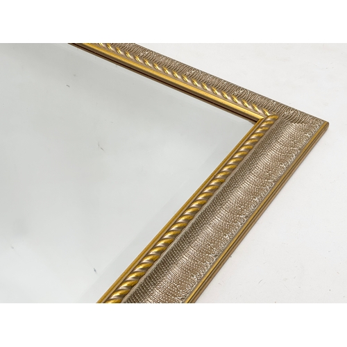 753 - A large gilt framed bevelled mirror. 103x88cm