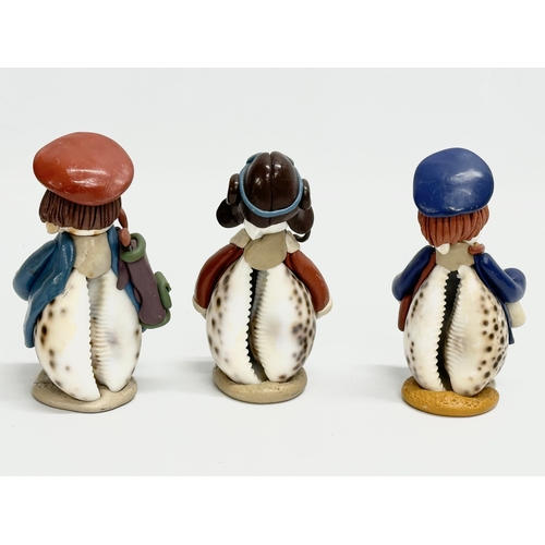 681 - A collection of cowrie seashell and clay figures. 16cm. 15cm