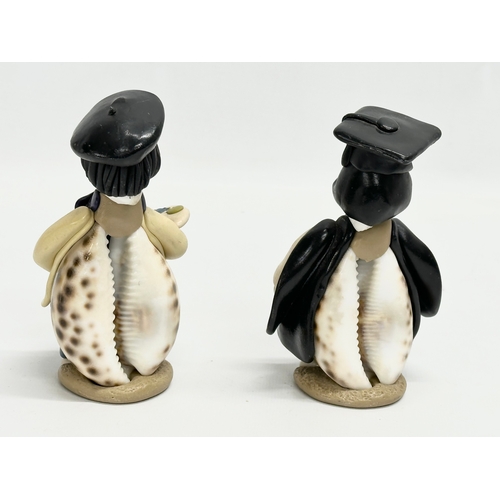 681 - A collection of cowrie seashell and clay figures. 16cm. 15cm