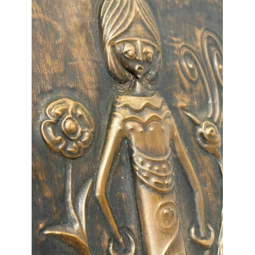 682 - A signed Early 20th Century embossed copper wall plaque. 11.5x20cm