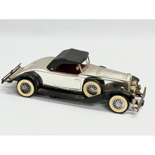 746 - A vintage Rolls Royce Phantom battery operated car. 25cm