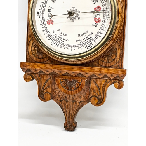 745 - A Victorian carved oak barometer. 28x84cm W