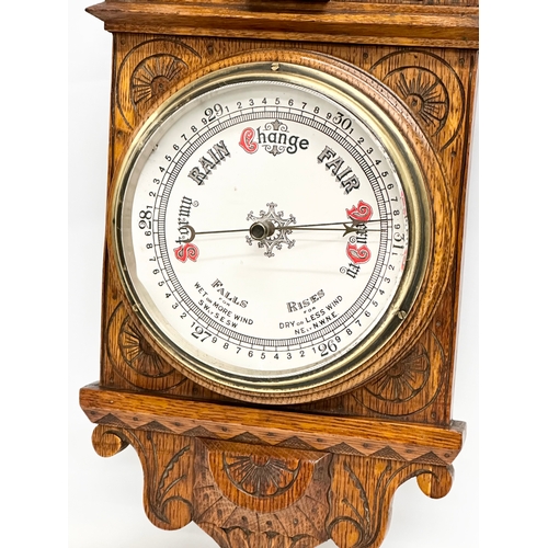 745 - A Victorian carved oak barometer. 28x84cm W