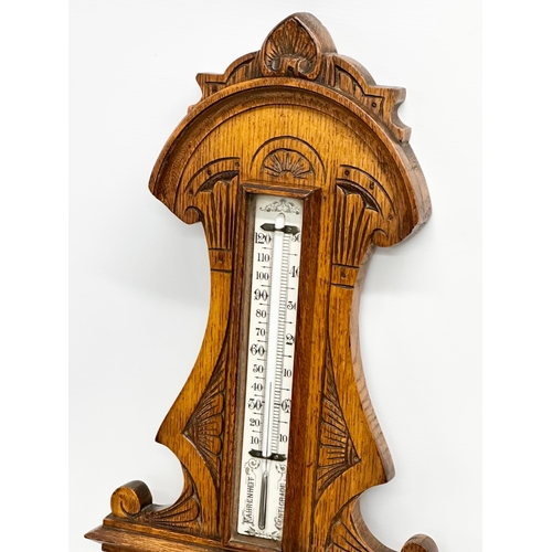 745 - A Victorian carved oak barometer. 28x84cm W