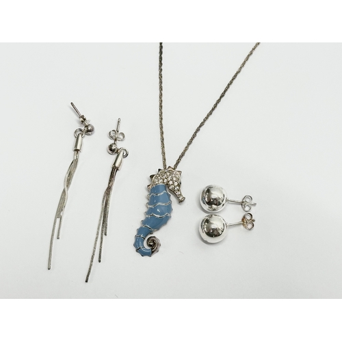 539P - A silver seahorse necklace and 2 pairs of silver earrings.