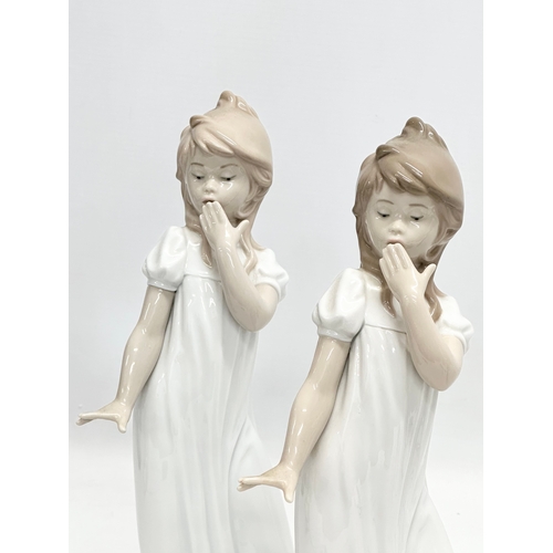 740 - A pair of large NAO ‘Yawning Girl’ figurines. 29.5cm