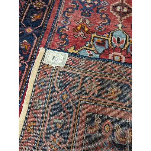 1009 - A large Middle Eastern style hand knotted rug. 130x211cm