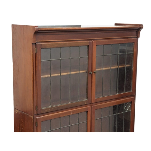 818 - An Early 20th Century mahogany stacking bookcase with astragal glazed doors by Minty. 89x30x150cm