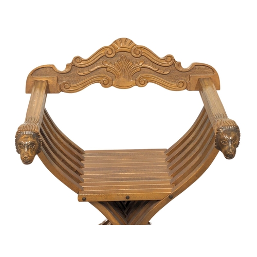 833 - An ornate beech X-framed chair