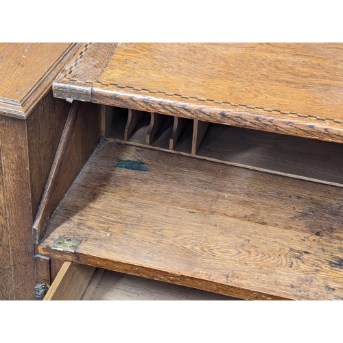 928 - An Early 20th Century Arts & Crafts inlaid oak writing bureau. Circa 1900. 100x43x111cm