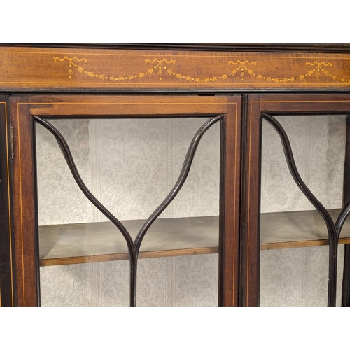 929 - An Edwardian inlaid mahogany display cabinet. 90x32x159cm