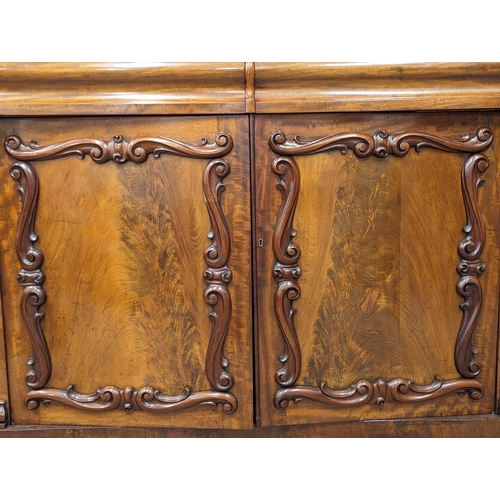 951 - An ornate Early Victorian mahogany bookcase. Circa 1840-50. 154x43x238cm