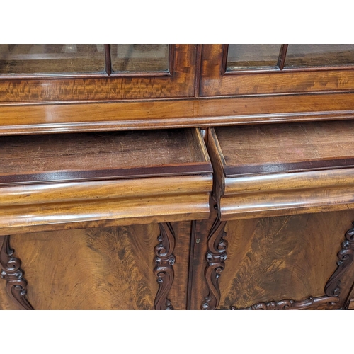 951 - An ornate Early Victorian mahogany bookcase. Circa 1840-50. 154x43x238cm