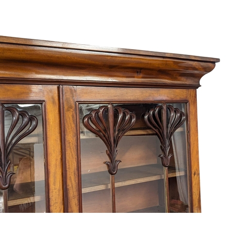 951 - An ornate Early Victorian mahogany bookcase. Circa 1840-50. 154x43x238cm