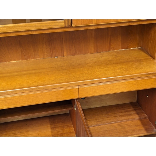 975 - A large McIntosh Mid Century teak living room unit. 180x41x193cm