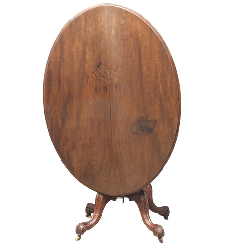 977 - A Victorian mahogany pedestal tilt top table. 121x89x73cm