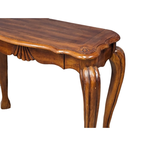 989 - An ornate mahogany hall table on Cabriole legs. 95x42x75cm