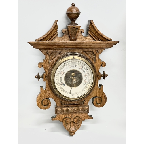 687 - A Late Victorian oak barometer with an Early 20th Century oak barometer. 85cm