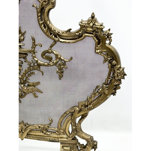 356D - A vintage French 18th Century style Rococo brass firescreen with wire mesh panel. 70x79cm