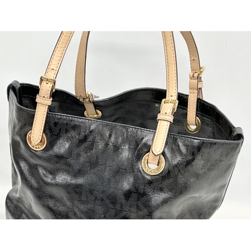 540R - A Michael Kors patent leather tote bag.