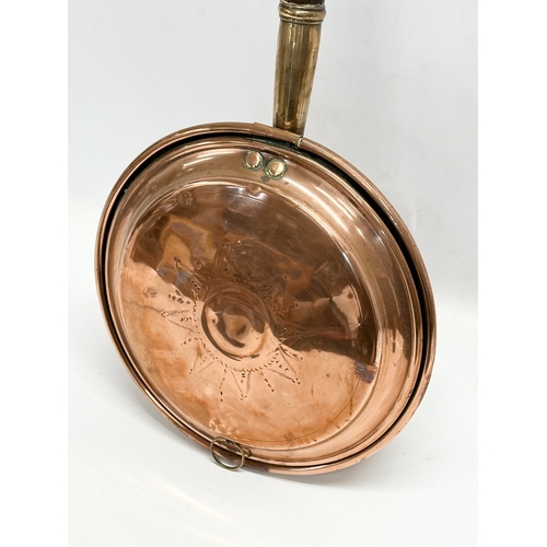 693 - A Victorian copper bed warmer. 110cm