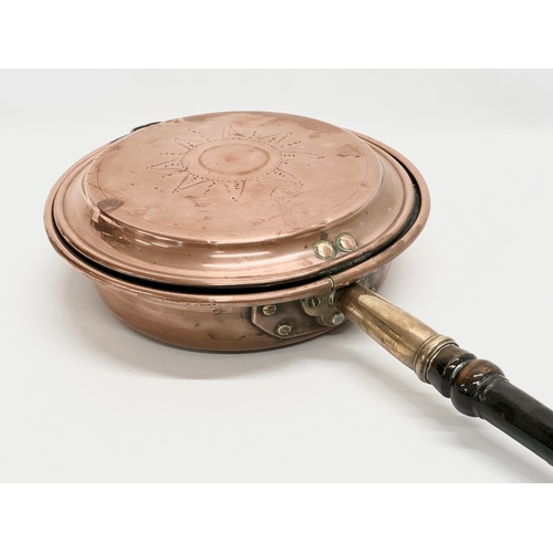 693 - A Victorian copper bed warmer. 110cm