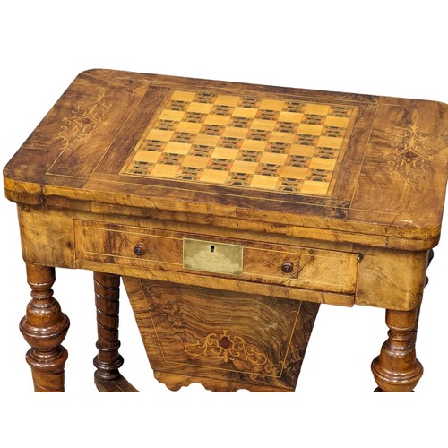 957 - A Victorian inlaid walnut turnover games table. 58x38x72.5cm