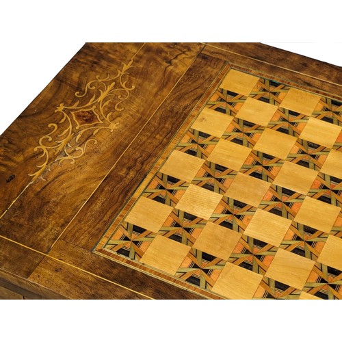 957 - A Victorian inlaid walnut turnover games table. 58x38x72.5cm