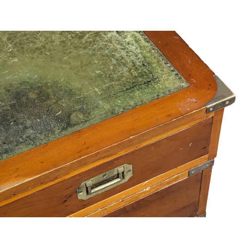 1012 - A Campaign style yew wood pedestal desk with leather top. 135x74x78cm