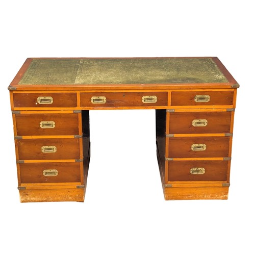 1012 - A Campaign style yew wood pedestal desk with leather top. 135x74x78cm