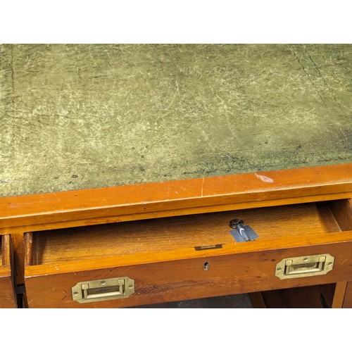 1012 - A Campaign style yew wood pedestal desk with leather top. 135x74x78cm