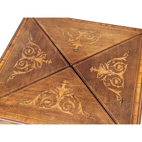 1030 - An Edwardian inlaid mahogany envelope turnover games table. 53.5x77.5cm