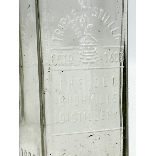 697 - A collection of 15 vintage The Old Bushmill’s Distillery Triple Distilled whiskey bottles. 24.5cm