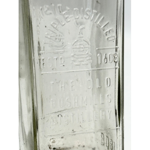 697 - A collection of 15 vintage The Old Bushmill’s Distillery Triple Distilled whiskey bottles. 24.5cm