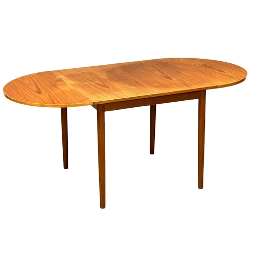 1052 - A Danish Mid Century teak drop leaf dining table in the manner of Arne Vidder. Open 168x84x73cm. Clo... 