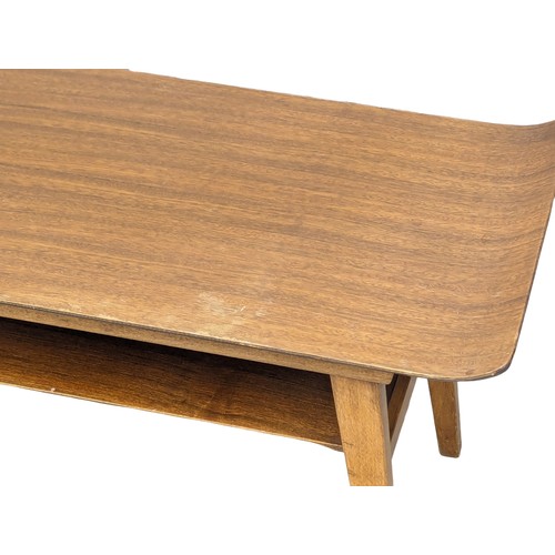 1055 - A 1960s Mid Century teak 2 tiered coffee table. 82x38x43cm