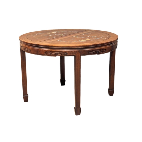 1057 - A Chinese rosewood 2 leaf extending dining table and 6 chairs with Mother of Pearl inlay.