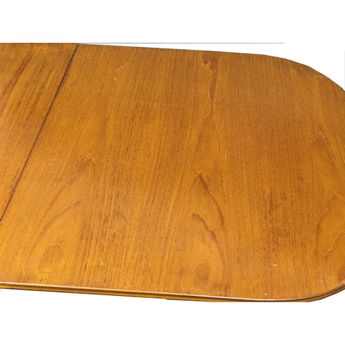 1058 - A Mid Century teak extending dining table by Beithcraft. Extended 213.5x92x76cm